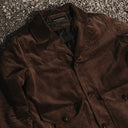 Brown corduroy jacket on a textured surface